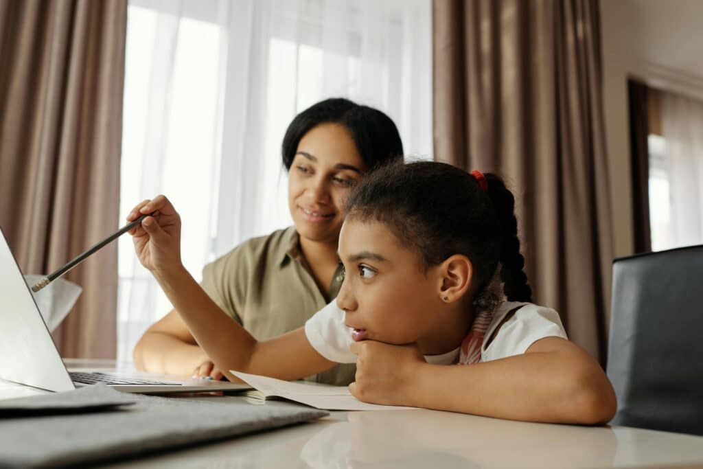 African Philanthropy Forum report unpacks gender justice and digital rights Mother and daughter engaged in online learning at home, using a laptop.