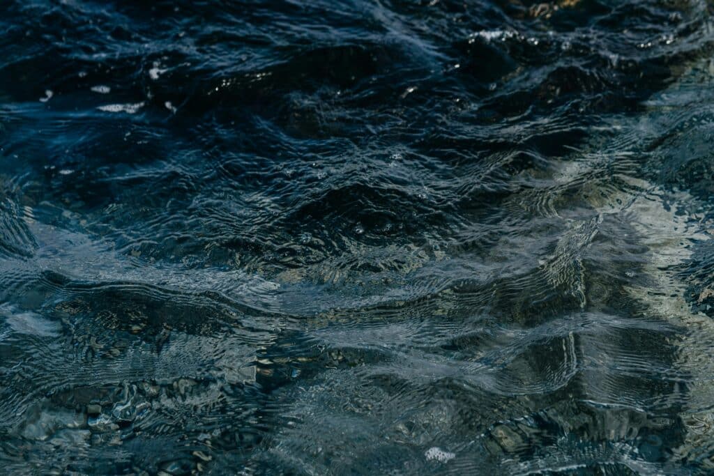 Mesmerizing ripples and waves across a shimmering water surface.